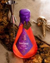 Load image into Gallery viewer, 1 Bottle of Gayuma. A pink Lychee Liquere in a clear bottle sealed with Purple wax and adorned with an Agimat.
